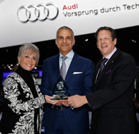 Mark Del Rosso, executive vice president and COO Audi America accepts Most Earth Aware SUV of the Year Award from Mike Martini, president Bridgestone OE America and Courtney Caldwell, editor in chief, Road & Travel Magazine