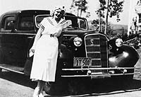 Jean Harlow by her Cadillac limousine.